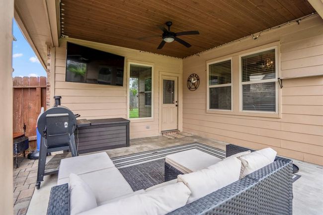 Looking back toward the back door, you get a cozy view of the covered patio’s warm wood ceiling and spacious layout—an ideal spot to enjoy morning coffee or unwind after a long day. | Image 32