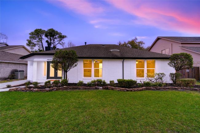The home’s stunning front elevation showcases a timeless and modern look with its freshly painted white brick exterior. This classic yet contemporary update enhances the home’s curb appeal, giving it a clean, sophisticated aesthetic. | Image 27