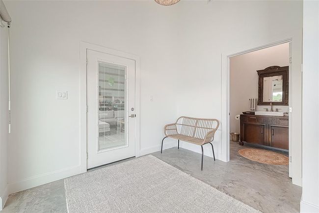 View of powder room and second door leading into garage. | Image 12