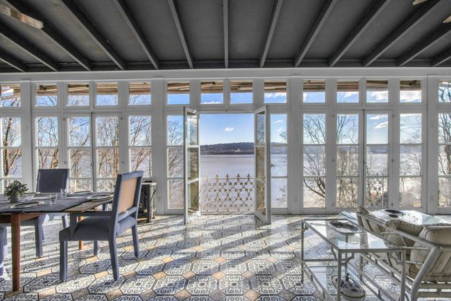 Sunroom / solarium featuring a water view and beamed ceiling | Image 11