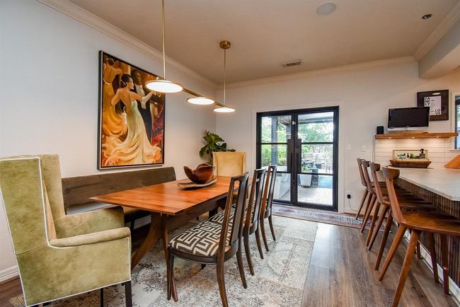 Just off the living room is the dining room. Perfectly situated next to the kitchen and opening to the outdoor screened porch, providing the perfect flow for entertaining. | Image 11