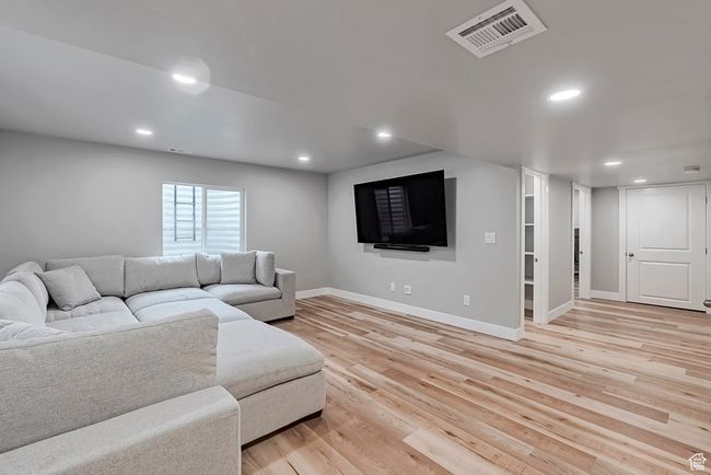 Living area featuring light wood-style floors, recessed lighting, and baseboards | Image 27