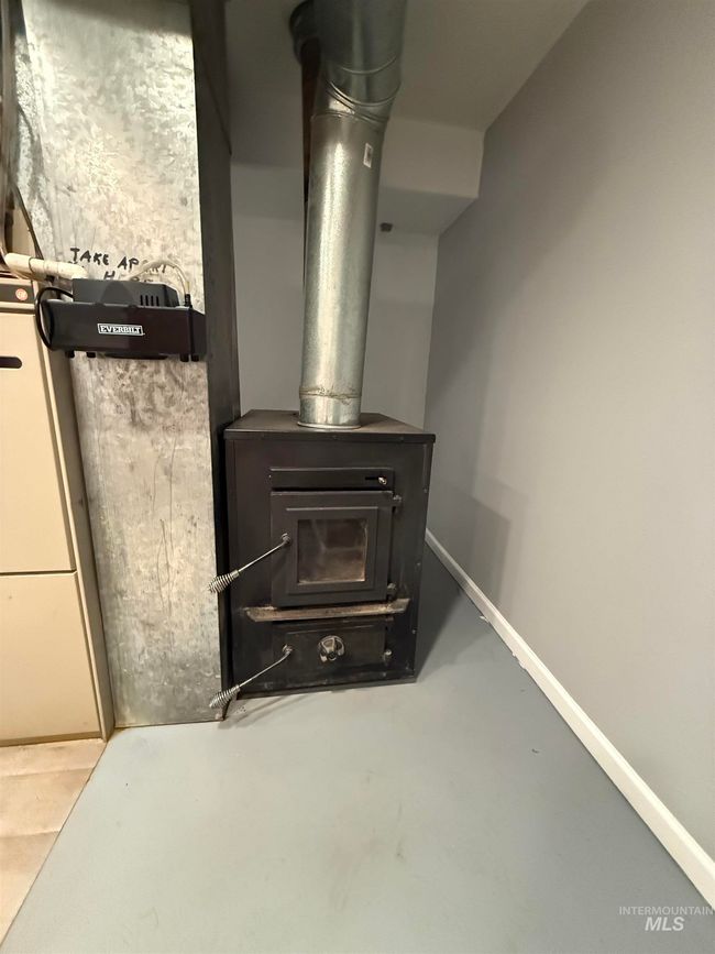 Detailed view of a wood stove and concrete flooring | Image 26