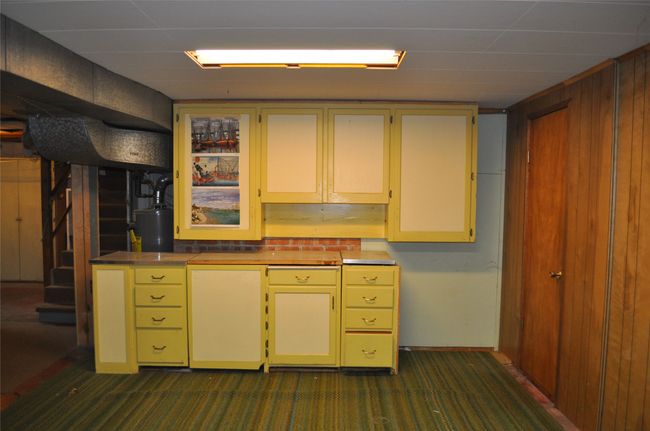 Basement with dark colored carpet, wood walls, and water heater | Image 26