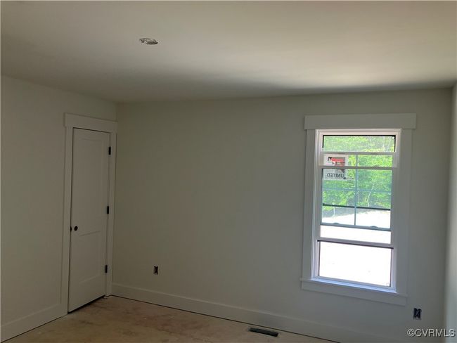 Empty room with baseboards and healthy amount of natural light | Image 15