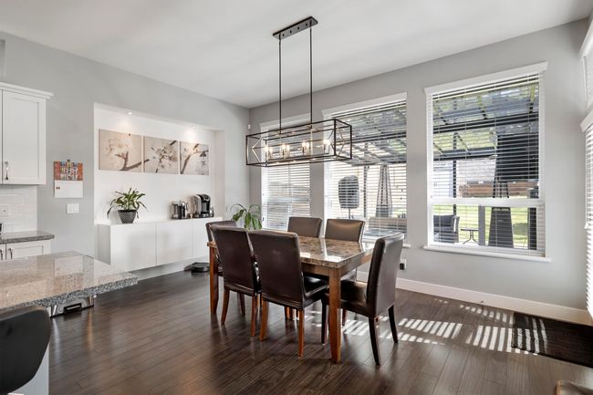 Dining area featuring baseboards, an inviting chandelier, and dark wood-style floors | Image 14