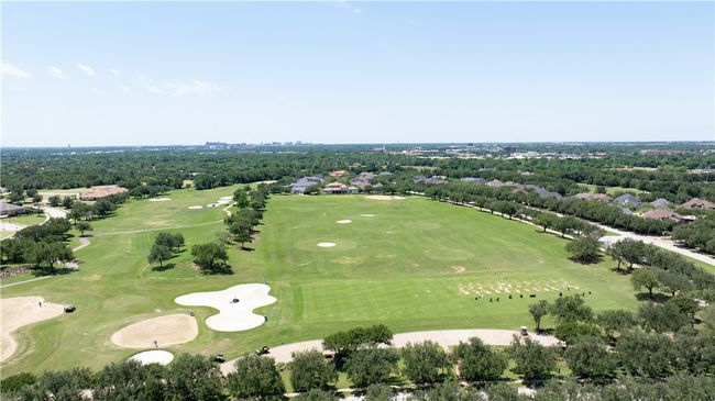 Bird's eye view of a tree filled landscape and a golf club | Image 35