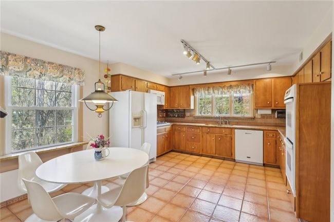 Large Eat in Kitchen with granite counters, tile backsplash and floor. | Image 10
