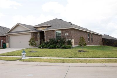 View of front facade with a garage and a front yard | Image 2