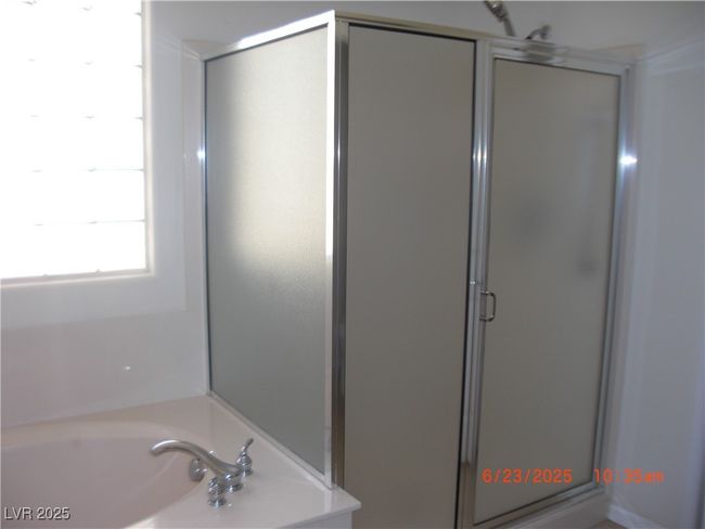 Full bath featuring a shower stall and a bath tub. | Image 10