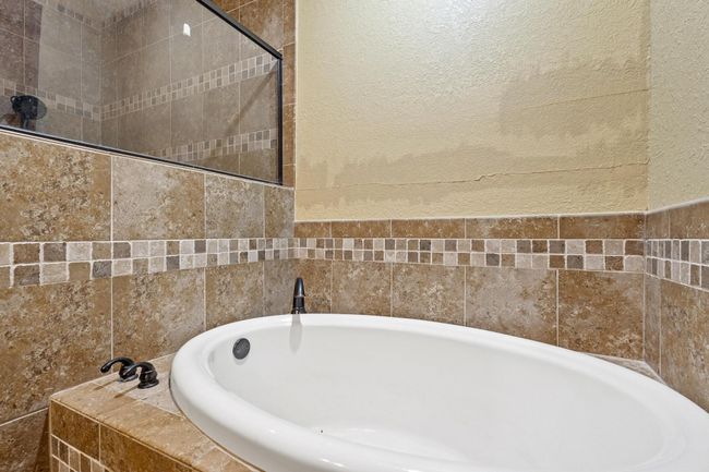 Full bathroom featuring a bath | Image 25