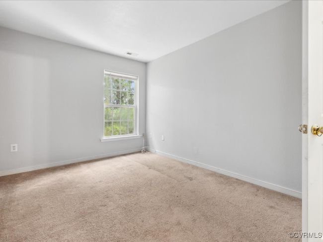 Spare room featuring carpet flooring and baseboards | Image 21