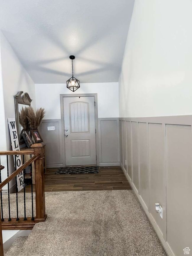 Entrance foyer featuring wainscoting, stairs, wood finished floors, and carpet flooring | Image 18
