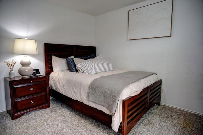 Carpeted bedroom featuring baseboards | Image 28