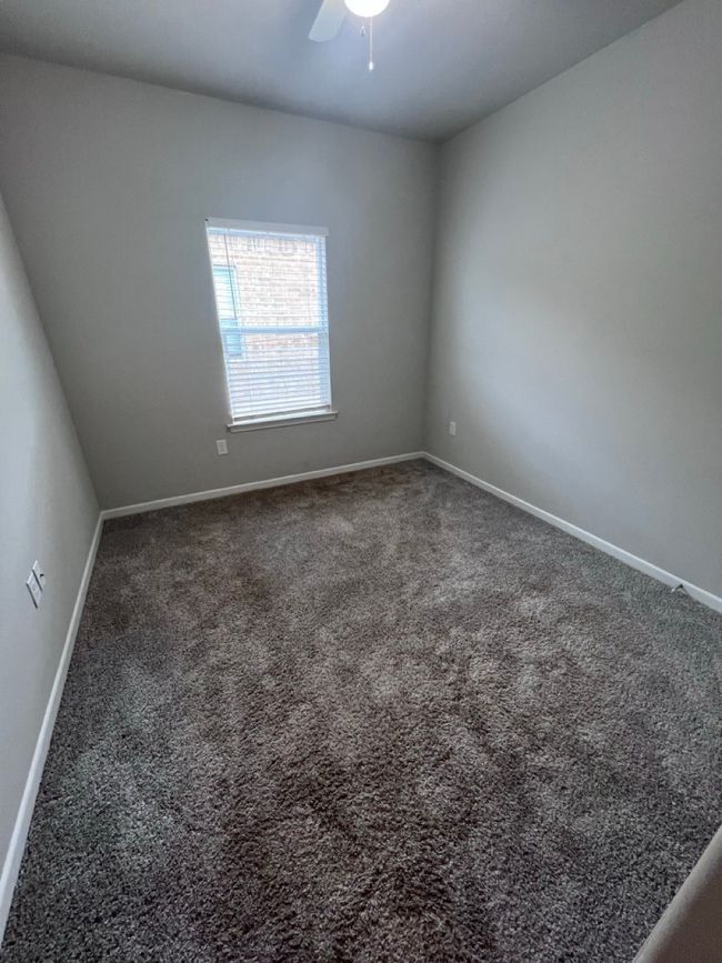 Spare room with carpet flooring, baseboards, and a ceiling fan | Image 11