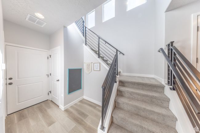 Stairs with wood finished floors, lovely windows that light up the house. | Image 7
