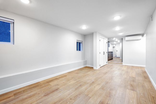 Interior space featuring light wood-style floors, baseboards, and a wall mounted AC | Image 5
