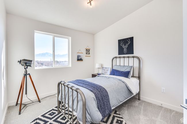 Carpeted bedroom with baseboards and vaulted ceiling | Image 17