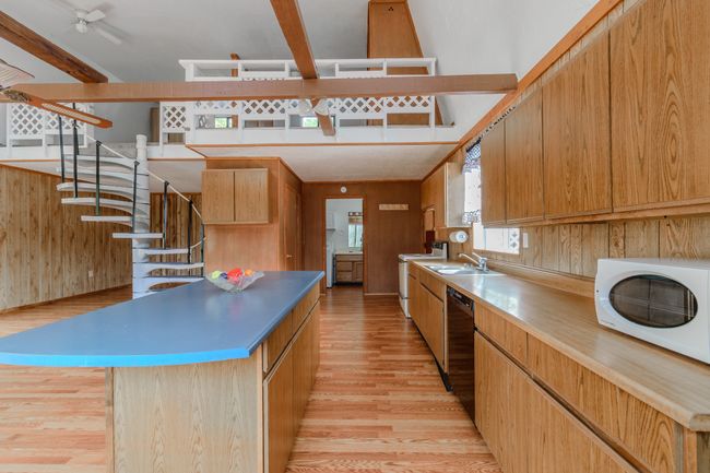 Kitchen with a center island, dishwasher, sink, light hardwood / wood-style flooring, and white range with electric stovetop | Image 25