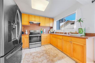 Stainless steel appliances, Corian counter top and cabinets added in past renovations | Image 3