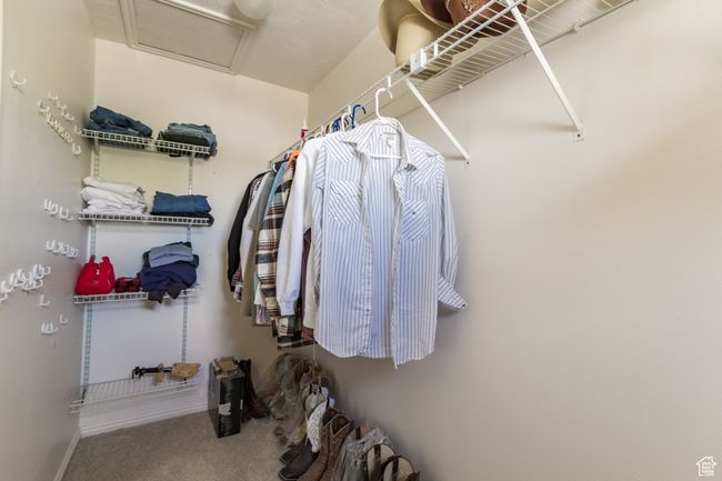 Walk in closet featuring carpet and attic access | Image 17