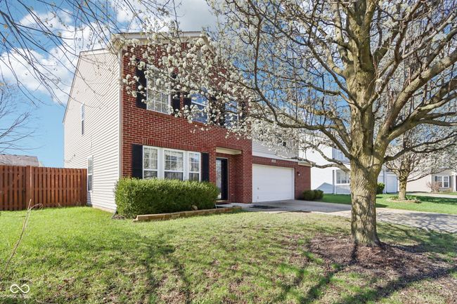 view of front facade featuring concrete driveway, a garage, and brick siding | Image 7