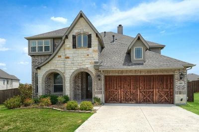 View of front of home featuring a front lawn and a garage | Image 2