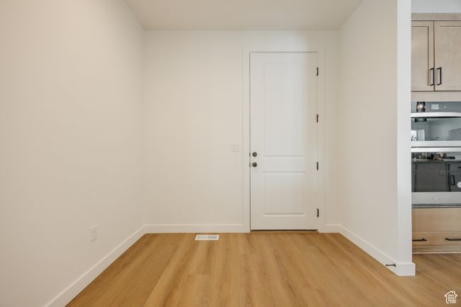 Unfurnished room with light wood-style floors and baseboards | Image 26
