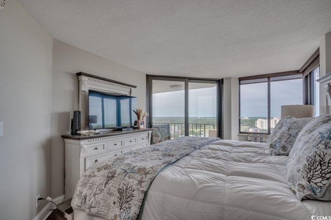 Bedroom featuring floor to ceiling windows, a textured ceiling, and access to outside | Image 17
