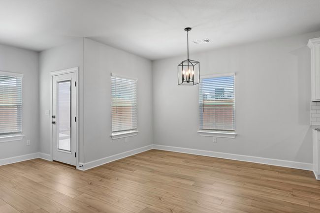 Adjacent to the family room, the dining room sets the stage for family meals and celebrations. It's a place where conversations flow as effortlessly as the layout. | Image 9