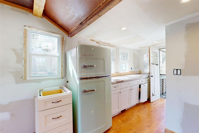 Kitchen with white cabinets, recessed lighting, light wood-style floors, and fridge | Image 15