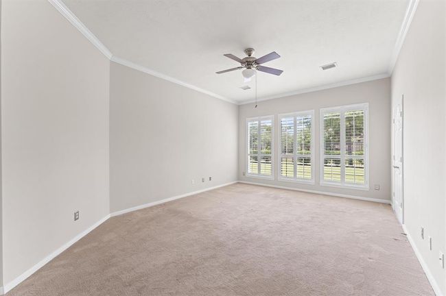 The spacious primary bedroom creates a serene atmosphere and the large windows panels presents a delightful view of the backyard. | Image 22