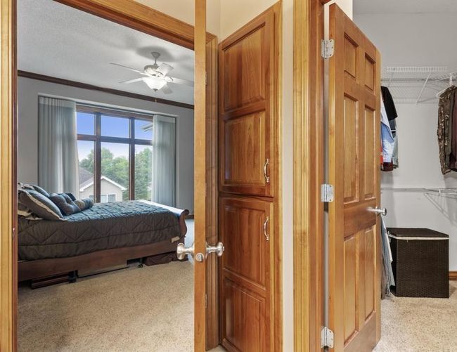 Primary bathroom features a linen closet and a spacious walk in closet with dual shelving. Enjoy 6 panel doors throughout showing the consistent quality craftsmanship this home was built with. | Image 19