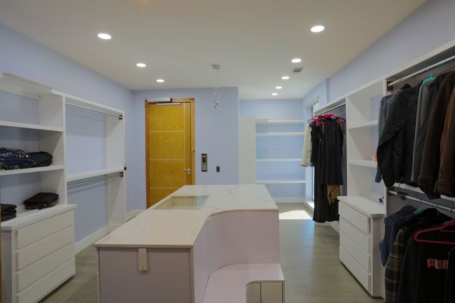 Spacious closet with light wood-type flooring | Image 9