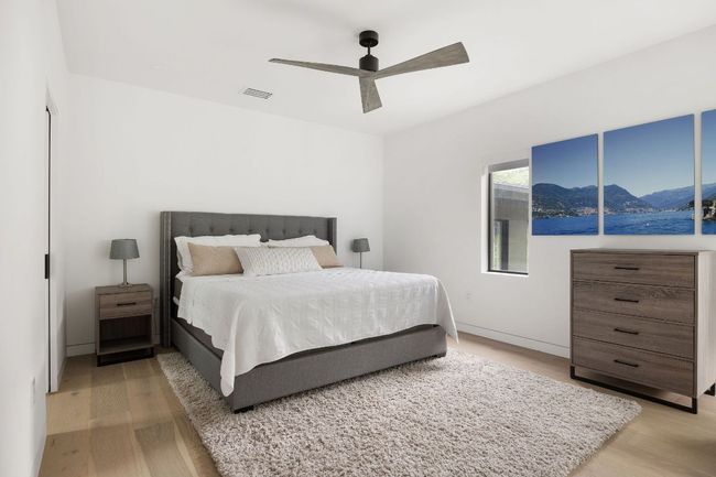 Bedroom featuring light wood-style flooring, a mountain view, and a ceiling fan | Image 36