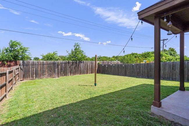 Fenced backyard featuring a patio area | Image 34