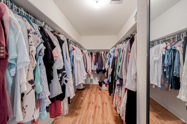 Spacious closet with light wood-type flooring | Image 25