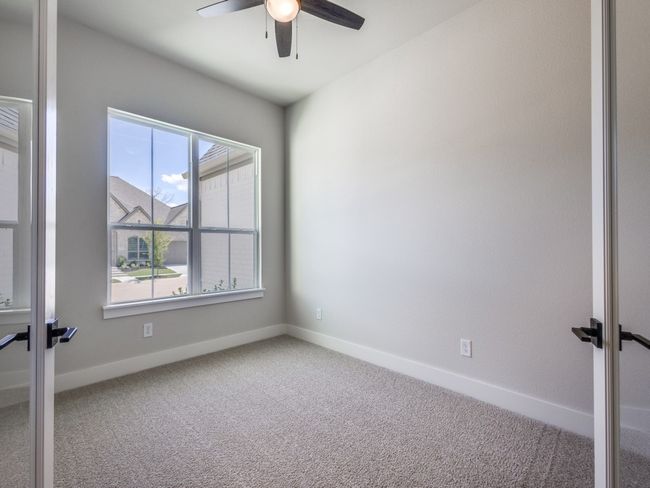 Offering a grand entrance with glass front French doors, your private home office is the perfect place for work or play! | Image 4