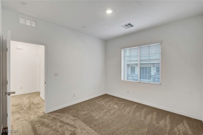 Carpeted empty room with visible vents and baseboards | Image 45