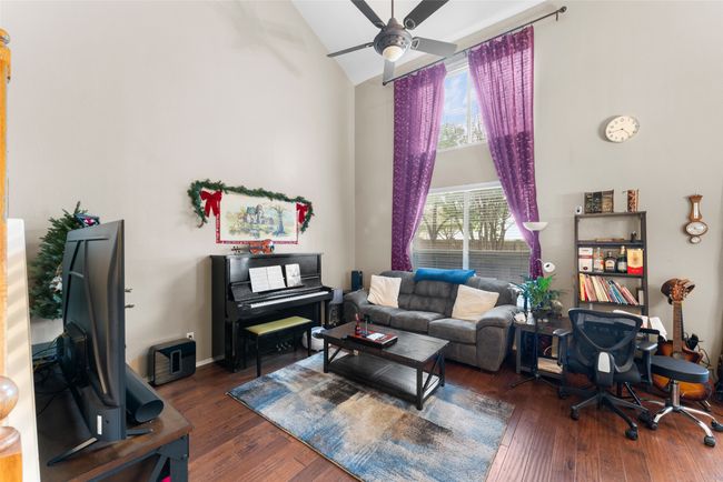 Living room featuring high vaulted ceiling, ceiling fan, and hardwood / wood-style floors | Image 6