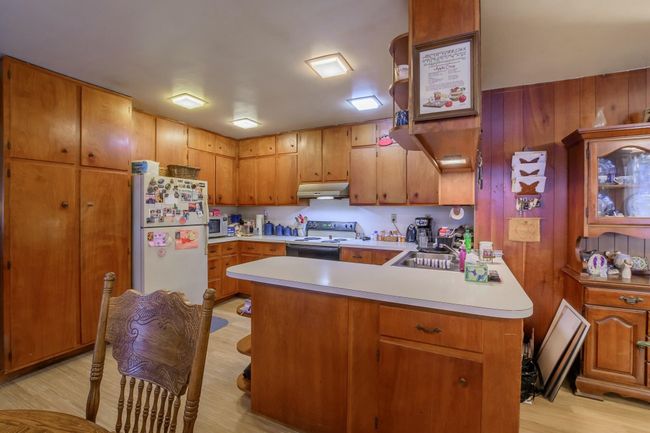 Kitchen with wood paneled cabinets. | Image 8