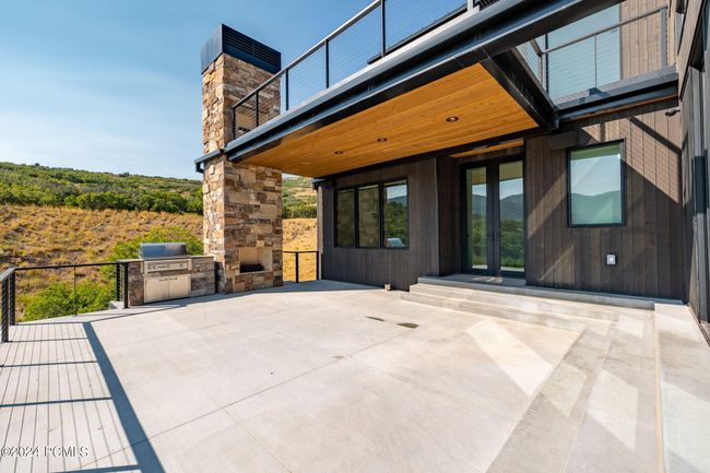 Heated patio main level with grill and fireplace | Image 17