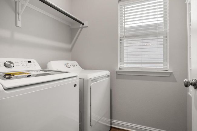 Laundry area featuring separate washer and dryer and baseboards | Image 16