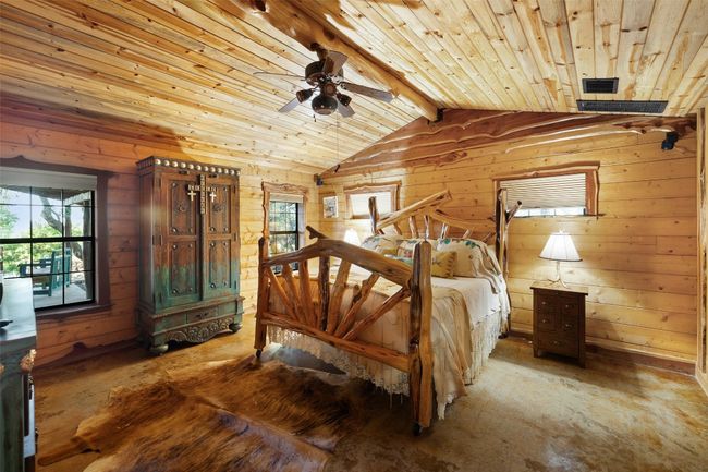 Bedroom featuring wooden walls and wooden ceiling | Image 20