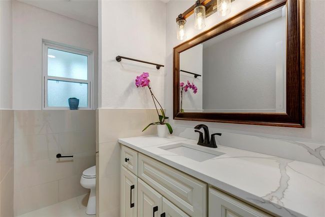 Newly remodeled Power room is conveniently located downstairs. New Quartz countertops, toilet and finishes. | Image 35