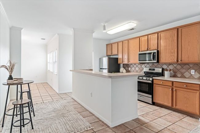 Stainless steel appliances are equipped in the kitchen. | Image 11