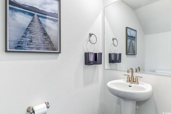 Bathroom featuring a sink and lofted ceiling | Image 16