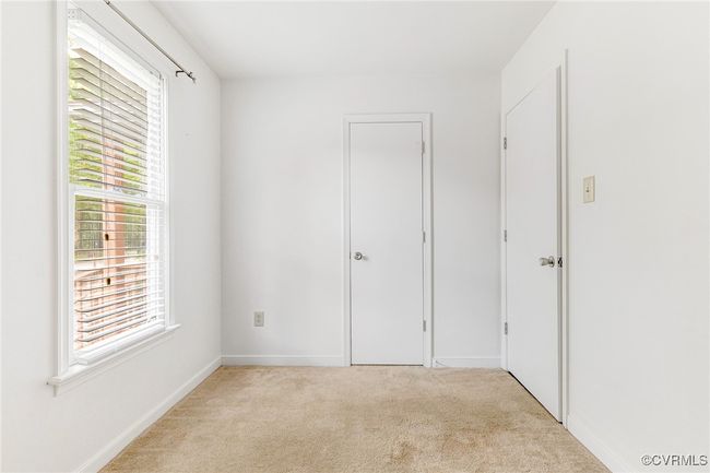 Unfurnished bedroom with multiple windows and light colored carpet | Image 19