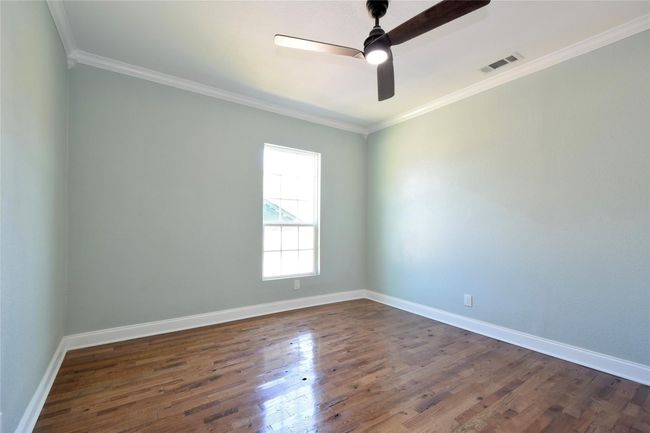 Spare room with a ceiling fan, dark wood-style flooring, and crown molding | Image 8