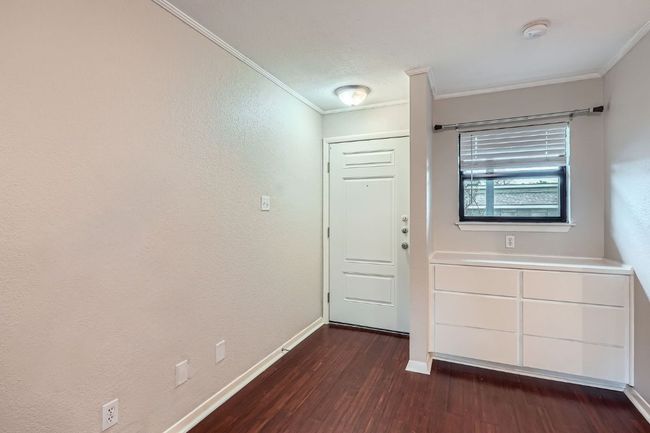 Entryway featuring baseboards, crown molding, and dark wood-type flooring | Image 5